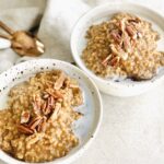 Two bowls of creamy vegan gluten-free pumpkin oatmeal cooked in instant pot