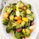 A plate of roasted broccoli and carrots.